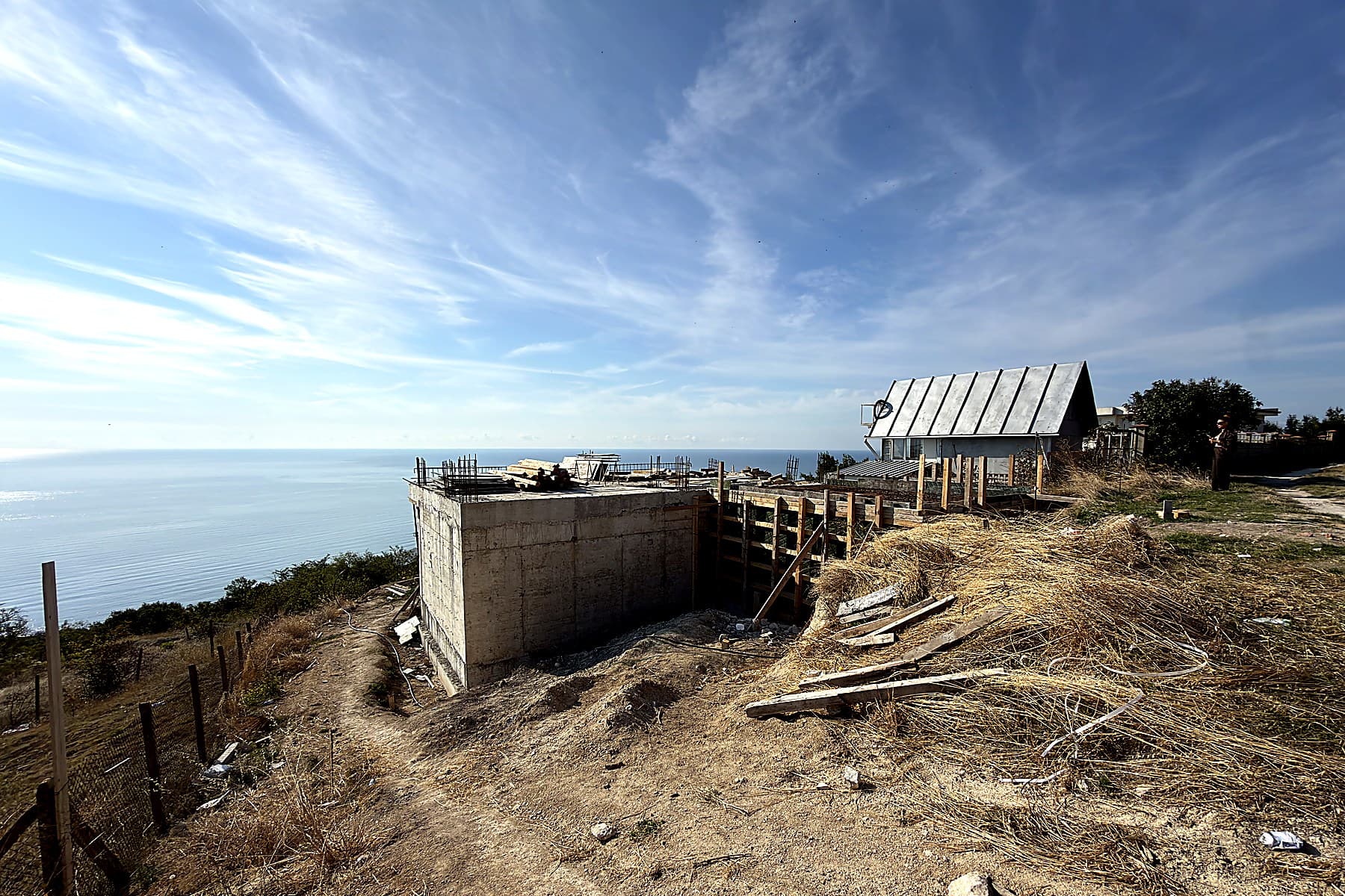 Above the bay, on the cliff edge